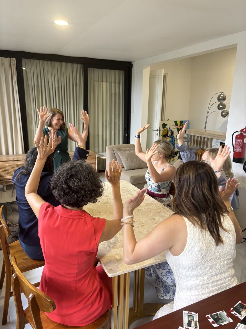 Antonietta and a group of women raising their hands together in celebration