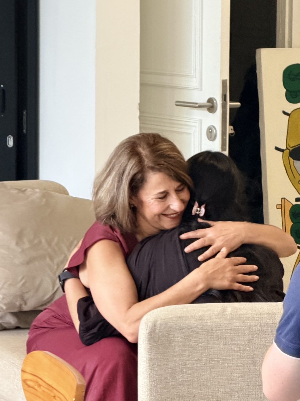 Antonietta warmly embracing a client